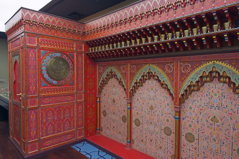 A richly painted room with a large brass astrolabe set into the wall, in the Museum of the History of Science and Technology in Islam