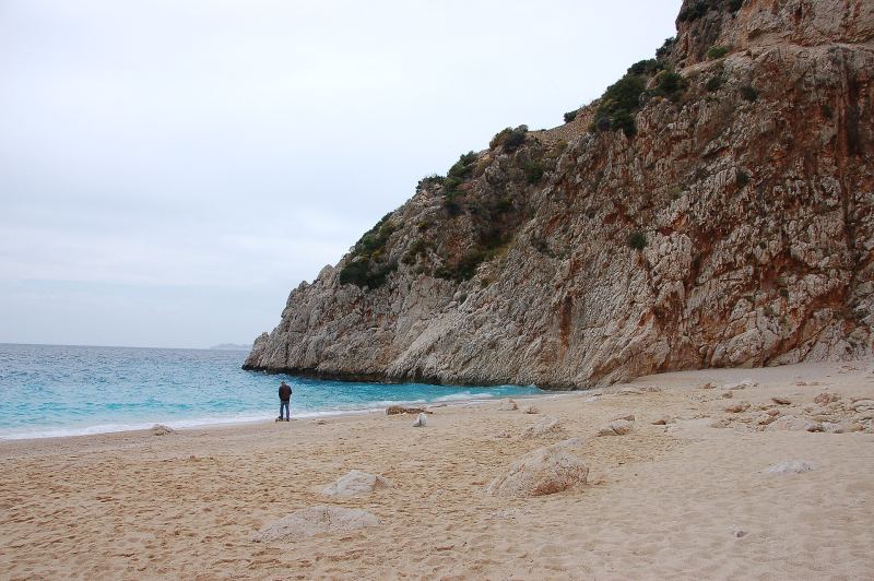Kaputaş beach: pale sand and clear water under a steep rocky cliff