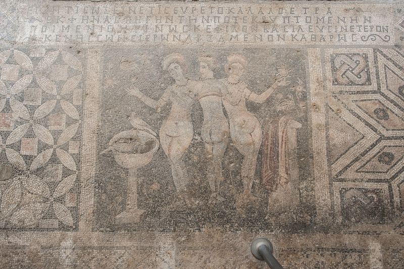 The Three Graces in the floor mosaic at Narlıkuyu, with the Greek inscription above them