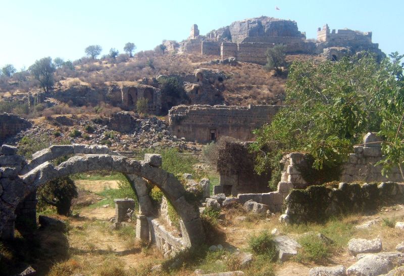 Stone ruins and an arch on the hillside at Tlos