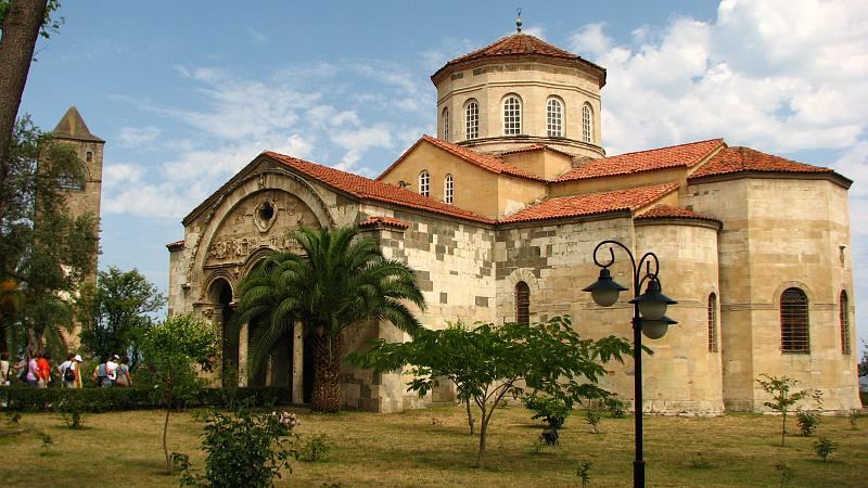 The stone church of Hagia Sophia in Trabzon with its bell tower in the garden